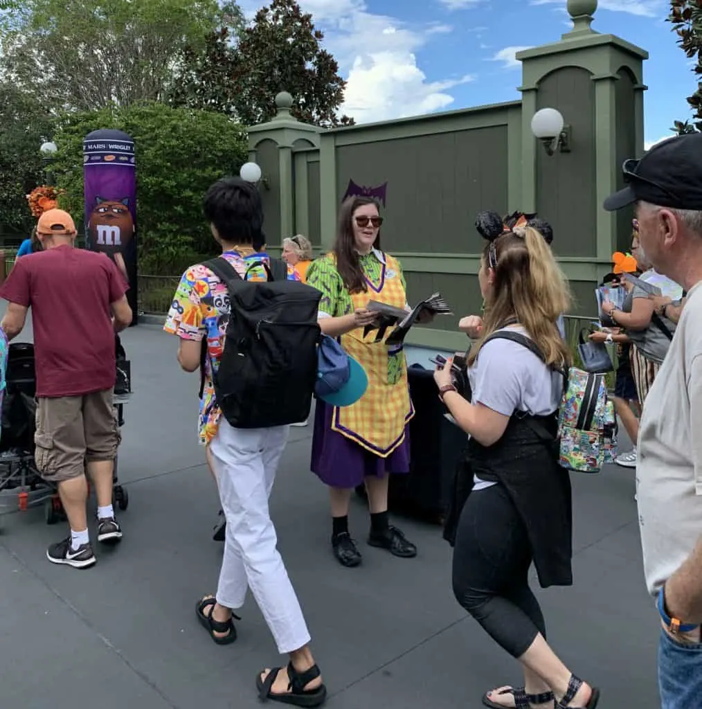 Cast members hand out treat bags at MNSSHP at the Magic Kingdom