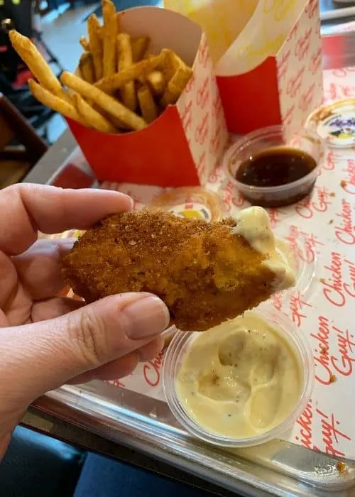 Chicken Guy Disney Springs - Chicken strip dipped in sauce