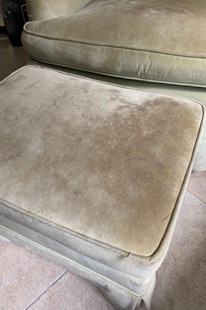 An extremely dirty light green ottoman, ready to be cleaned by our Bissell