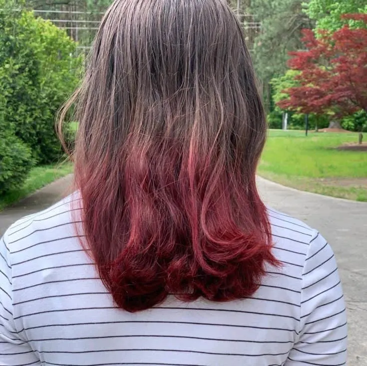 The results of Kool Aid Hair Dye on the ends of brown hair.