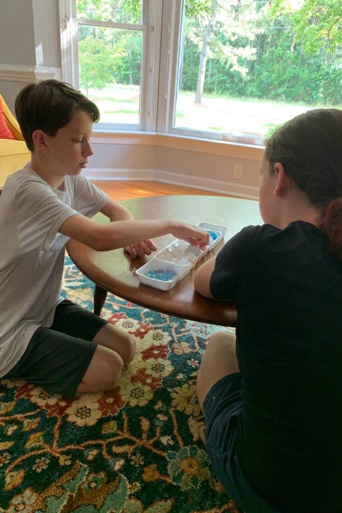 kids playing homemade mancala game