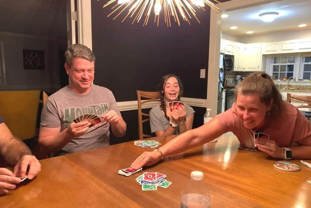 player reaching for more cards in Uno House Rules