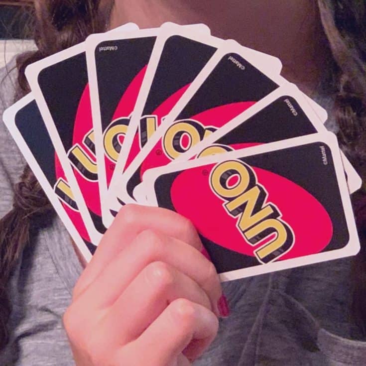 hand holding cards for Uno House Rules game