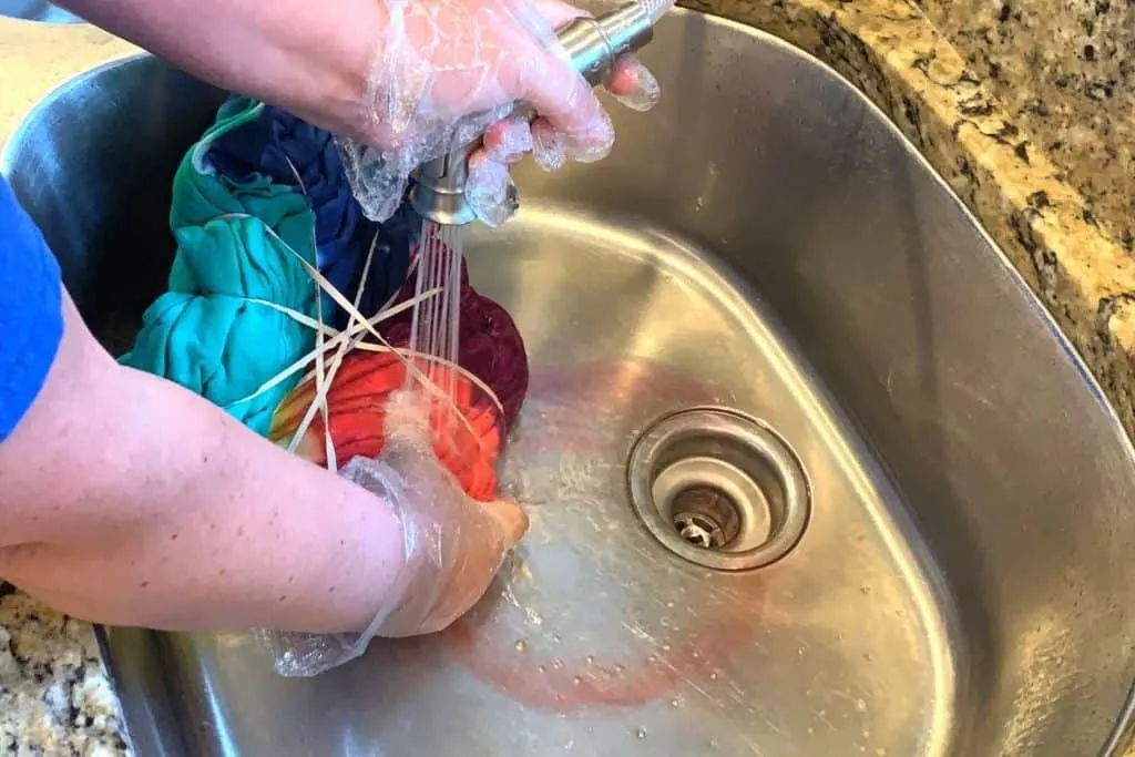 tie dye hoodie being rinsed after dying