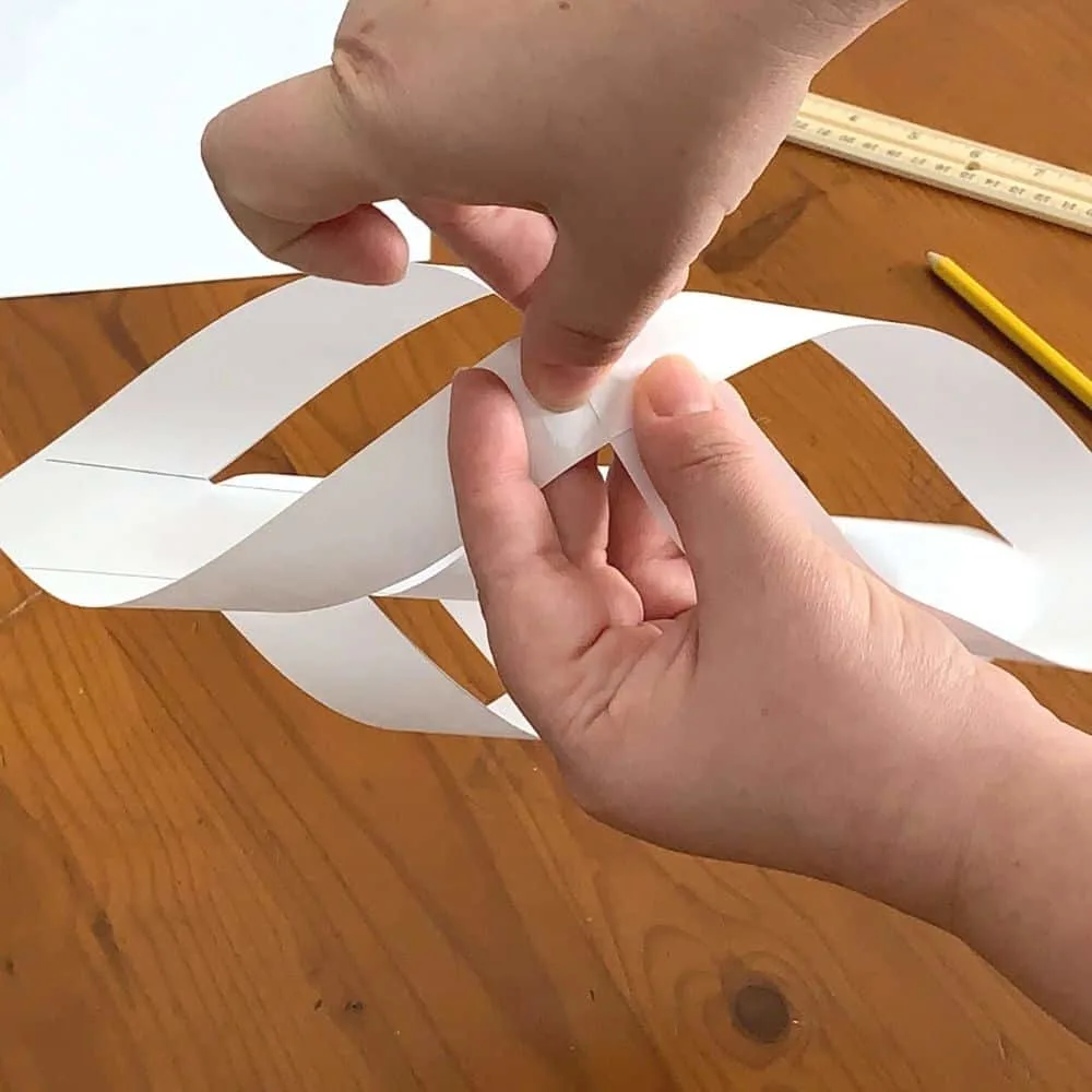 taping final flaps of a 3d snowflake