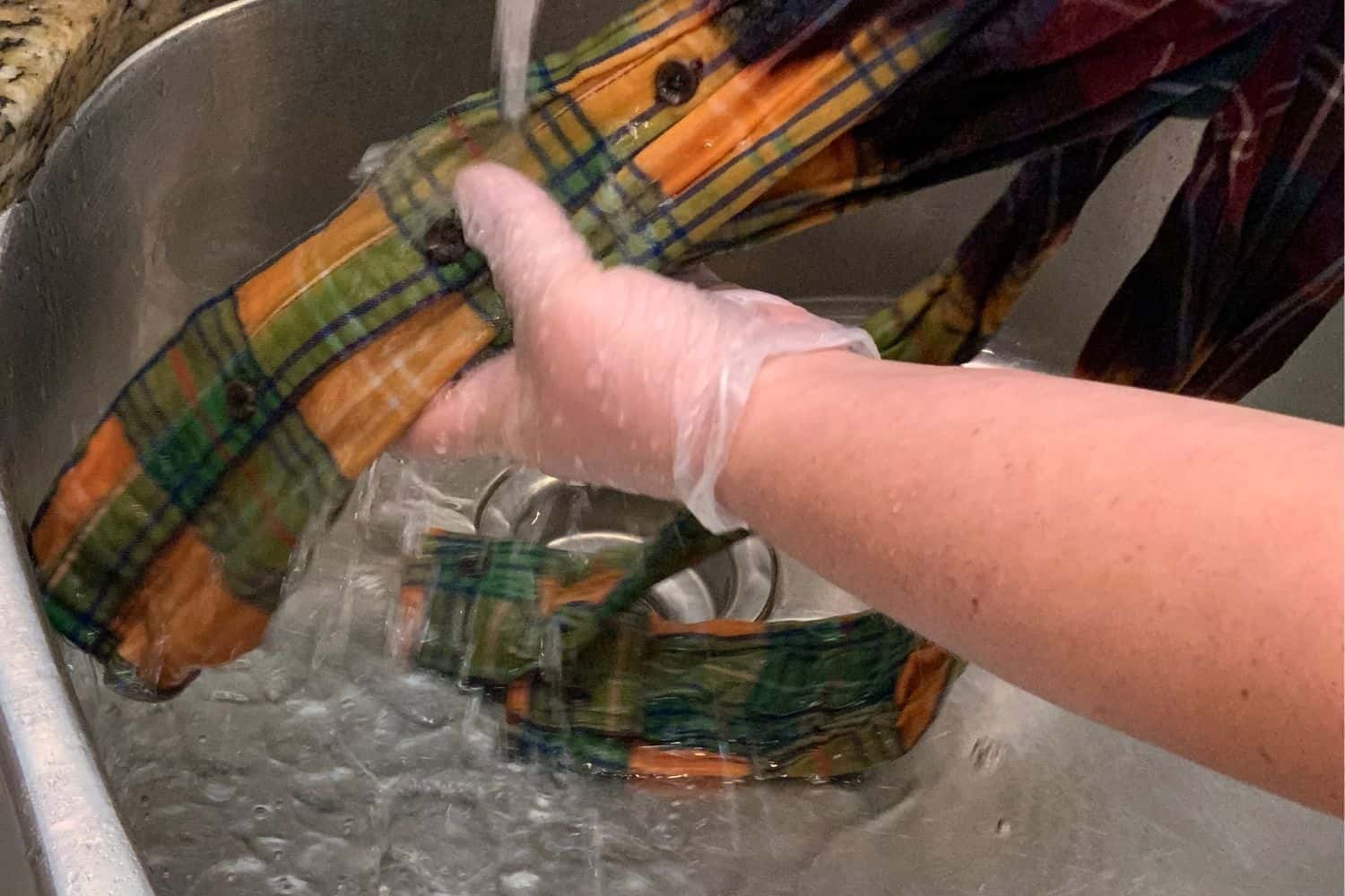 rinsing the bleach from the flannel shirt
