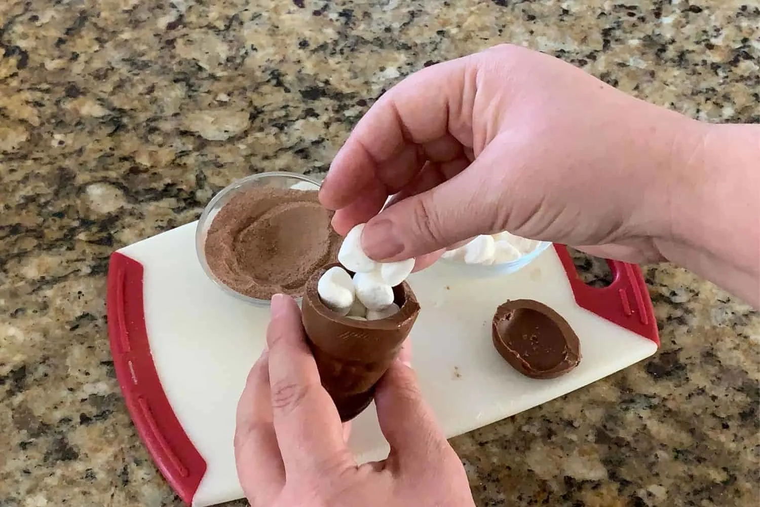 filling the chocolate snowman with marshmallows