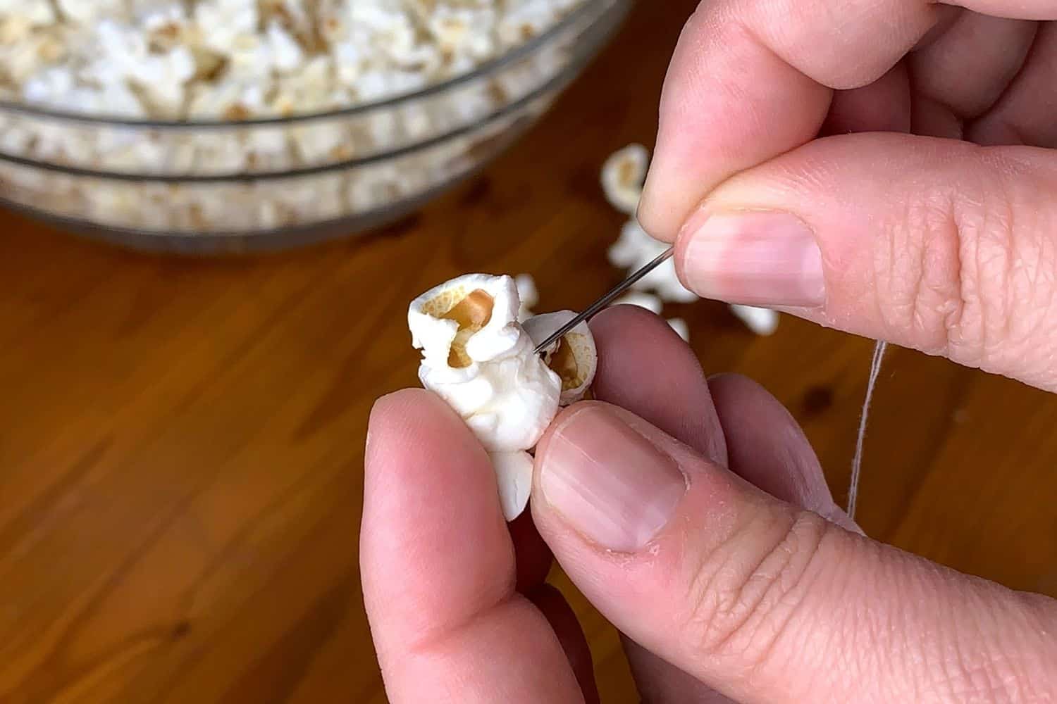 a needle about to string popcorn