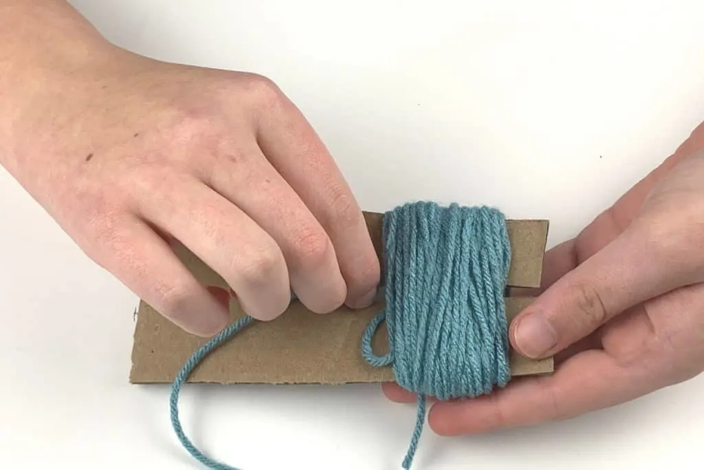 Thread the yarn around the bundle for your pom pom