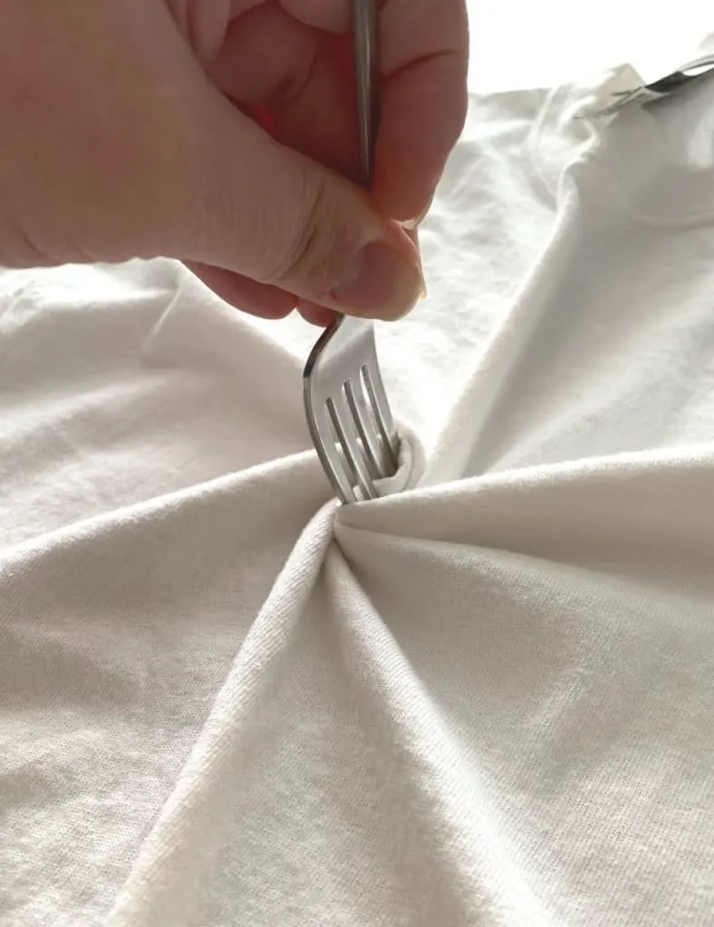 Spinning the fork to create the spiral tie dye pattern