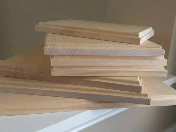 a stack of wooden boards for state string art