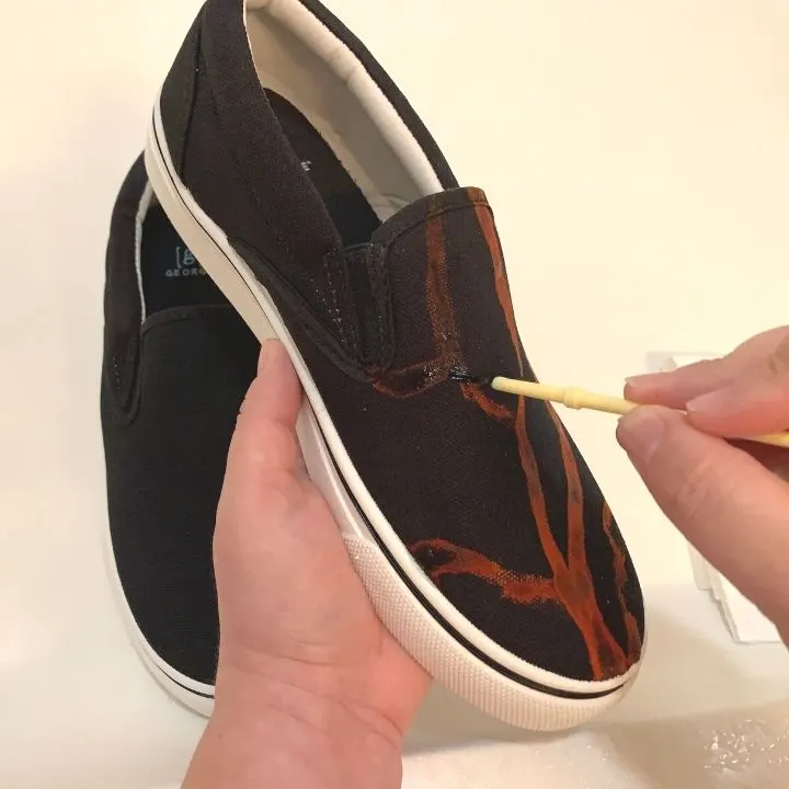 Applying bleach cleaner to the shoes