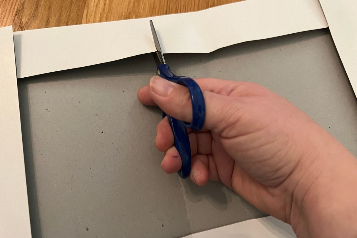 Cutting flaps in a shirt top box to create a diy gift box