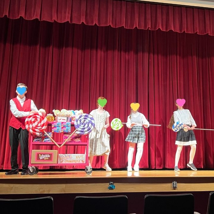 Kids using pool noodle lollipops in a play as props