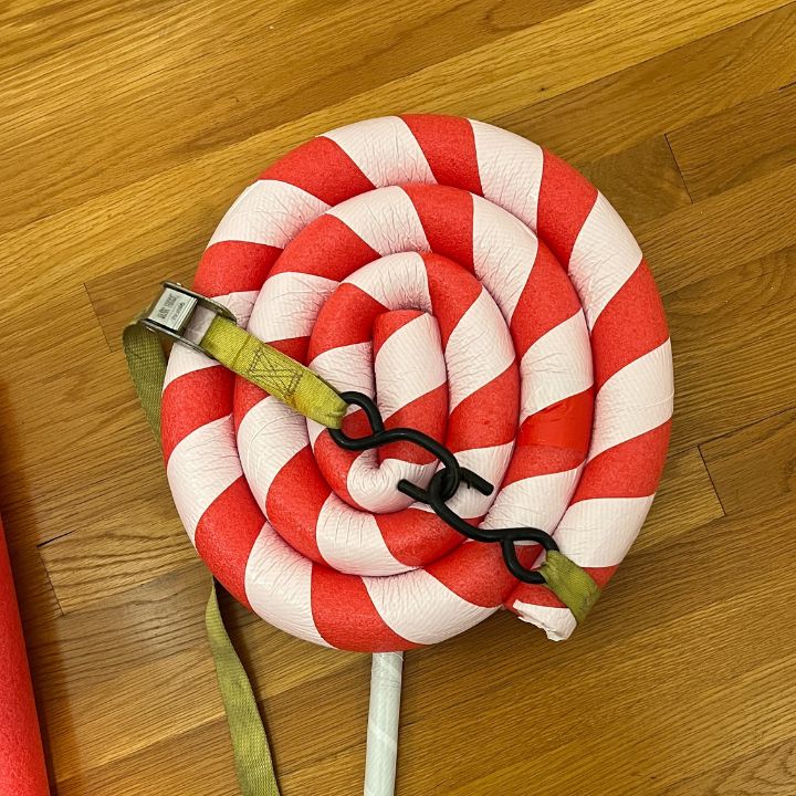 Pool noodle lollipop held together by a ratchet strap